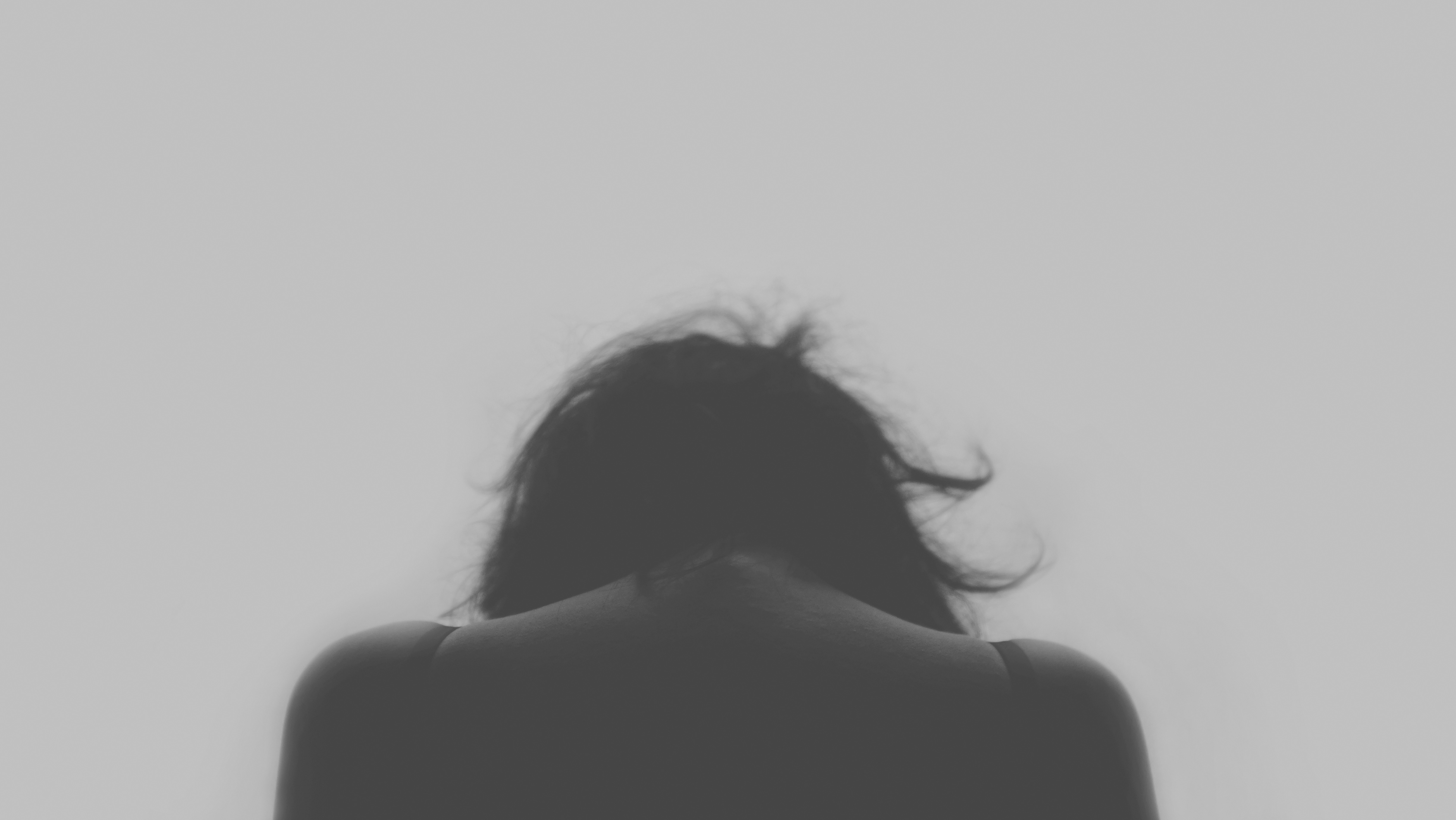Canva - Depressed Woman Looking Down